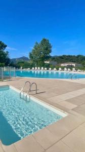 a large swimming pool with chairs in the middle of it at French Riviera Golf in Mandelieu-La Napoule