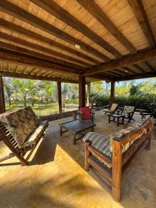 a porch with chairs and a wooden roof at Cabaña Olas del Viento 1 in San Bernardo del Viento