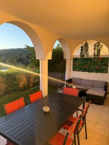 a dining table and chairs in a room with a view at French Riviera Golf in Mandelieu-La Napoule