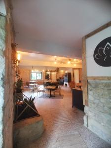 a living room with a table and a dining room at Moulin de Monpoisson in Le Puy