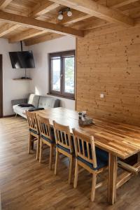 a dining room with a wooden table and chairs at Kovarov26 in Frymburk