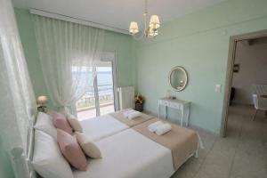 a bedroom with two beds and a large window at Vintage Home in Ouranoupoli