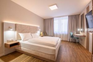 a hotel room with a bed and a window at Altstadt Hotel in Würzburg