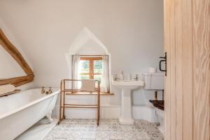 a white bathroom with a tub and a sink at 4 Bed in Shrawley oc-s34861 in Shrawley +30 photos