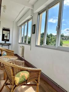 a room with chairs and windows with a view at Casa La Ería in Sevares