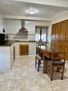 a kitchen with a table and chairs in a room at Casa La Ería in Sevares