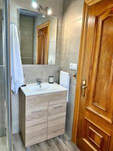 a bathroom with a sink and a mirror at Casa La Ería in Sevares +37 photos