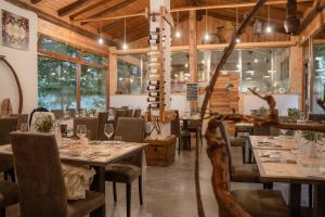 a dining room with tables and chairs and windows at Maison Champriond in Rif