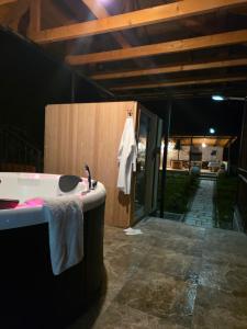 a bathroom with a bath tub and a sink at Winery Matisi in Babaneuri +59 photos