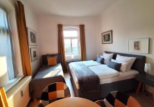a small bedroom with a bed and a window at Villa Taxus-Smokers not welcome in Dresden