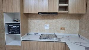 a kitchen with a counter top and a stove at Cherished Homes in Ikeja +3 photos