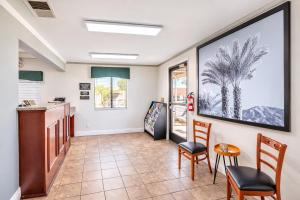 a kitchen with two chairs and a table at Super 8 by Wyndham Barstow in Barstow