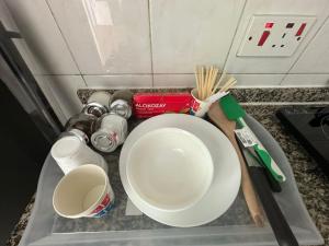 a counter top with a bowl and utensils on it at Abu Dhabi City Private Room Late Check out 2pm in Abu Dhabi