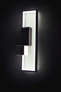 a light on a wall with a light on it at Central Residence Sky Apartment in Rădăuţi