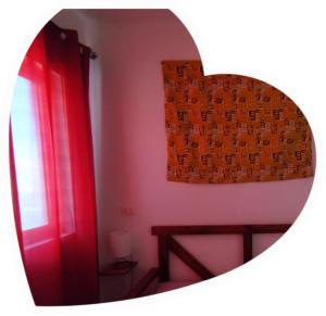 a mirror reflecting a room with a red door and a window at Ca Gabbiano 6 in Santa Maria