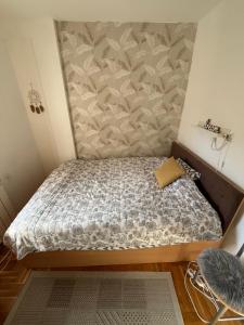 a small bedroom with a bed in a room at ANKA apartman in Smederevo +2 photos