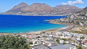 a view of a beach with houses and the ocean at Executive Sea View Apartment in Glencairn