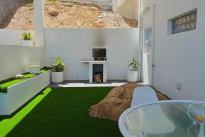 a living room with green carpet and a fireplace at Executive Sea View Apartment in Glencairn