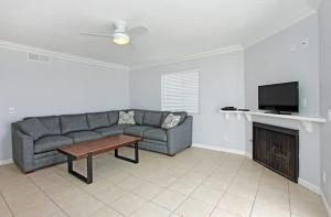 a living room with a couch and a fireplace at 8-Bedroom Beachfront Triplex – Ideal for Extended apts in Newport Beach