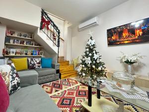 a living room with a christmas tree in it at Duplex Mino, Pazari i Vjetër Korçë in Korçë
