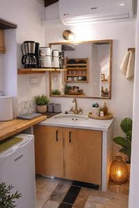 a kitchen with a sink and a mirror at MonemBlue in Monemvasia +9 photos