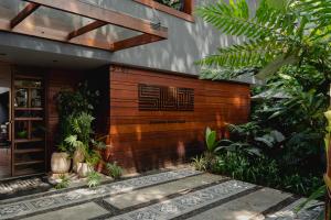 a building with a sign on the side of it at Sui Boutique Hotel in Medellín