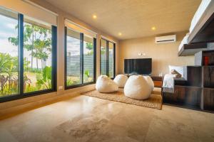 a living room with two white pillows on the floor at Casa Riverstone in Dominical