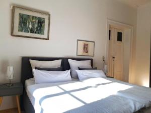 a bedroom with a large bed with white pillows at Villa Taxus-Smokers not welcome in Dresden +12 photos