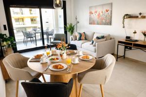 a living room with a table with food on it at Casa Anna - Velapi - Los Alcázares in San Javier