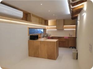 a kitchen with wooden cabinets and a sink at 경상북도 감성숙소 청화소담 in Yeongcheon