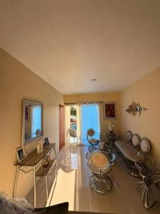 a living room with a table and chairs in it at Comforthub Apartment in Higuey