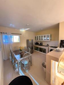 a kitchen and dining room with a table and chairs at Comforthub Apartment in Higuey