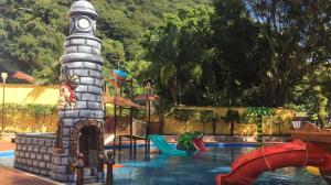 a pool with a water park with a water slide at La Casita Azul in Orizaba