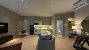 a living room with a couch and a kitchen at Suites 43 Juan Llorens in Valencia +10 photos