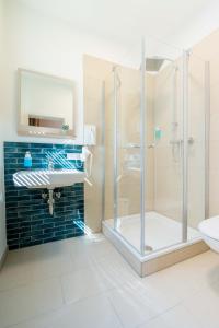 a bathroom with a shower and a sink at Altstadt Hotel in Würzburg +44 photos