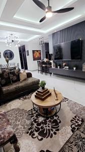 a living room with a couch and a coffee table at Villa Elegance-3 min Walk to the Beach-20 mins to Ochi Rios in Richmond