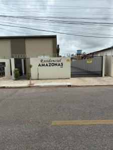 a building with a sign on the side of it at Amazon LOFT 08 in Sorriso