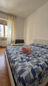 a bedroom with a bed with a blue and white comforter at Bartolo Health and Wellness in Cagliari