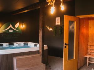 a jacuzzi tub in a room with a sign at Holiday Home Zelena Oaza in Sarajevo +44 photos