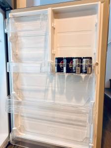 an open refrigerator with its door open with drinks in it at Just Peace Homes in Moncton