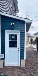 a blue house with a white door and a window at Just Peace Homes in Moncton