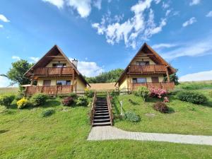 a house on a hill with stairs leading to it at Domki Całoroczne Pod Lasem in Łobozew