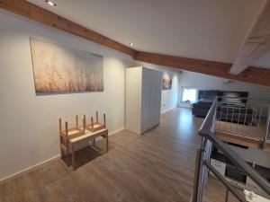a living room with a staircase and a painting on the wall at SchwalbenNest Pfeifers OdenwaldNest in Rimbach