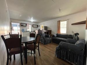 a living room with a table and a couch at Windy days Apartments in Utila