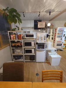 a kitchen with a counter with appliances in it at 宿 inn TEK-TEK in Sanuki