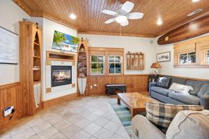 a living room with a couch and a fireplace at IC2 - Endless Summer Cottage in Manteo