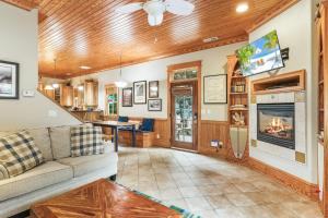 a living room with a couch and a fireplace at IC2 - Endless Summer Cottage in Manteo