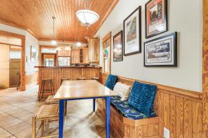 a dining room with a table and blue chairs at IC2 - Endless Summer Cottage in Manteo