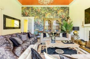 a living room with a couch and a table at Unique Manor House PLUS Jacuzzi PLUS BBQ Cabin in Maybole