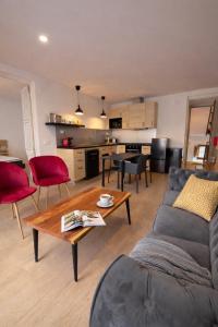a living room with a couch and a table at 31CaL QuEROL Boutique centre Puigcerdà in Puigcerdà